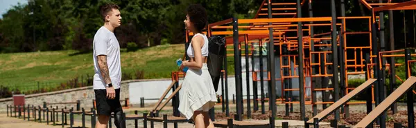 Two friends, one with a prosthetic leg, share an outdoor workout in the sun-filled park. — Stock Photo