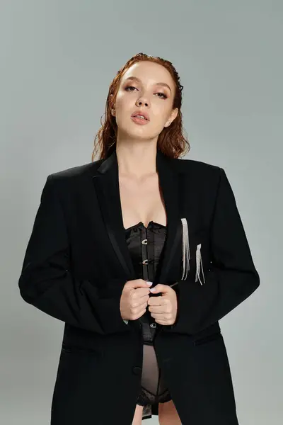 A striking woman showcases fashion with flair in a modern studio environment. — Stock Photo