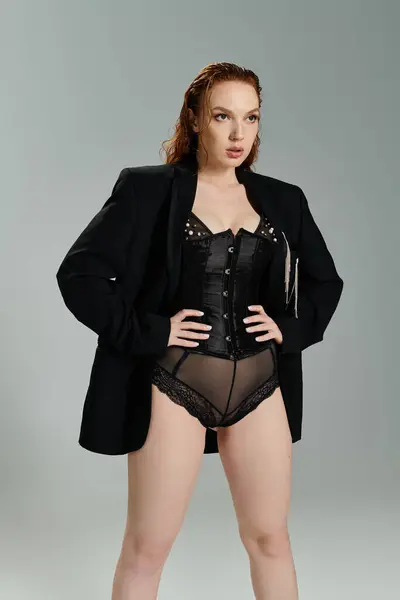 A striking red haired woman showcases her fashion forward look with poise. — Stock Photo