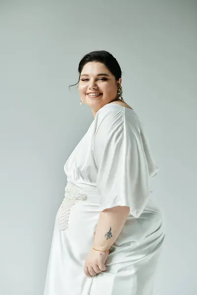 Celebrating beauty and confidence, a plus size bride dazzles in her stunning white dress and elegant earrings. — Stock Photo