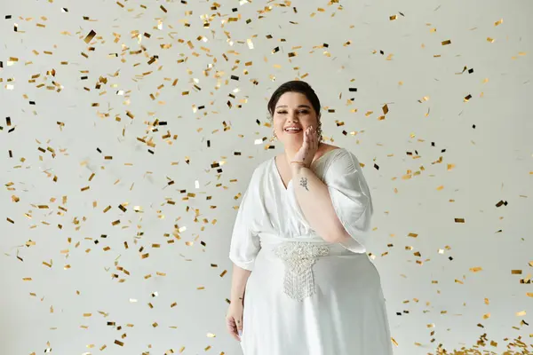 A blissful bride in a white gown beams with happiness as golden confetti falls around her. — Stock Photo