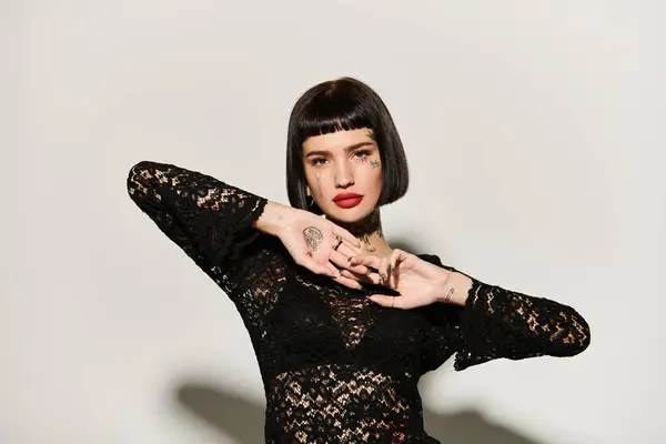 A fashionable woman showcases her unique tattoos and confident style. — Stock Photo