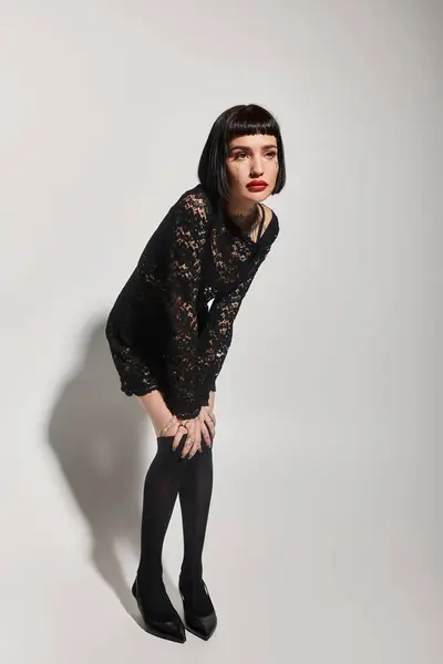 A striking young woman with tattoos shows off her fashionable look. — Stock Photo