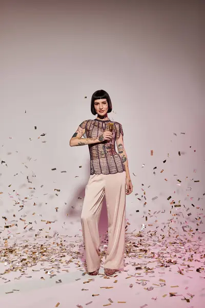 A fashionable woman poses confidently while surrounded by colorful confetti. — Stock Photo