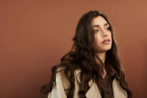 A young woman showcases her autumn style in a cozy studio, emphasizing trends for the fall season with elegance. — Stock Photo