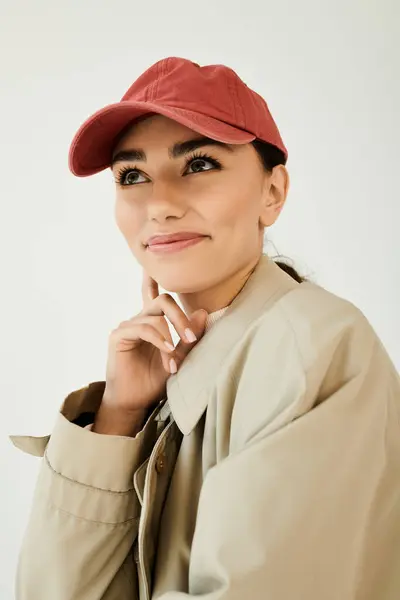 A young woman poses gracefully in a chic autumn outfit, bringing warmth and style to a studio setting filled with charm. — Stock Photo