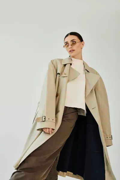 A young woman captivates with her stylish autumn outfit, radiating charm and elegance in a contemporary studio. — Stock Photo