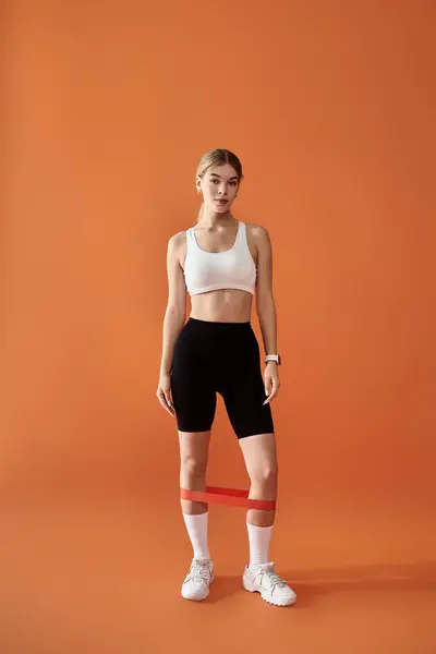 A sportswoman showcases her emotional strength while posing in fitness gear. — Stock Photo