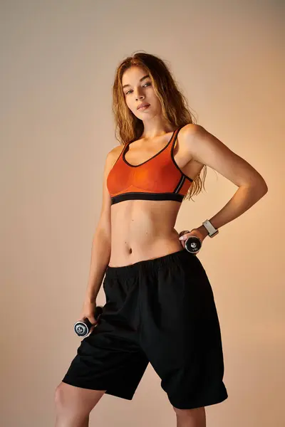 A determined athlete stands confidently while holding dumbbells, exuding passion and strength. — Stock Photo