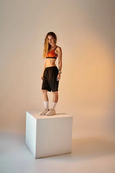The athlete stands poised on a pedestal, exuding strength and emotion in a calm setting. — Stock Photo
