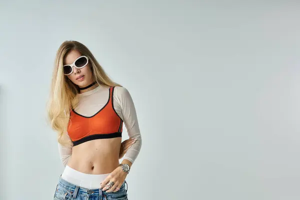 A stylish young woman poses confidently, showcasing a trendy outfit with a modern flair. — Stock Photo