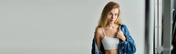 A young beautiful woman poses confidently, showcasing her natural beauty and style indoors. — Stock Photo