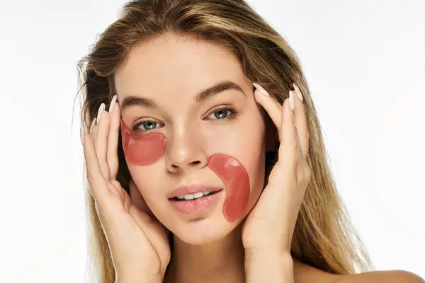 A young woman embraces self care and tranquility with her skincare routine and face patches. — Stock Photo