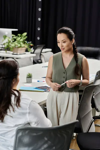 Two professional women share insights during a productive meeting in a stylish workspace. — Stock Photo