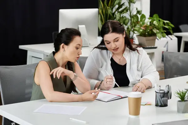 Two professionals engaged in a discussion while reviewing notes in a stylish office setting. — Stock Photo
