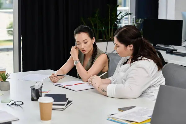 Two professional women engage in an insightful discussion at a stylish office workspace. — Stock Photo