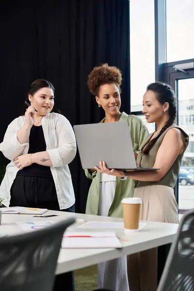 Three stylish businesswomen collaborate and share insights in a contemporary workspace. — Stock Photo
