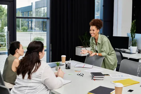 A group of professional women collaborates excitedly in a chic office space. — Stock Photo
