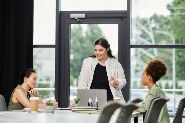 Trois femmes d'affaires élégantes s'engagent dans une discussion collaborative dans un bureau contemporain. — Photo de stock