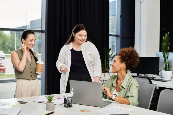 Three professional women engage in an inspiring discussion while working in the office. — Stock Photo
