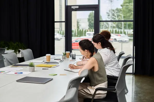 Elegant women engage in focused discussions and brainstorming at a stylish office table. — Stock Photo