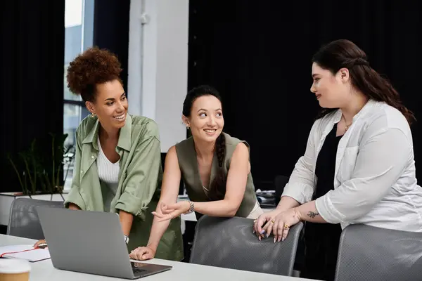 Drei Geschäftsfrauen diskutieren dynamisch in einem zeitgemäßen Büroumfeld. — Stockfoto