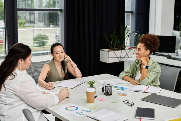 A group of professional women collaborate creatively in a modern office space. — Stock Photo