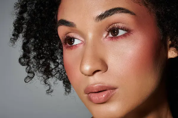 A stylish woman poses confidently, showcasing her trendy look and glamorous makeup. — Stock Photo