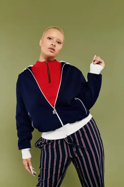 Confident bald woman in colorful clothes smiles against a green background. — Stock Photo