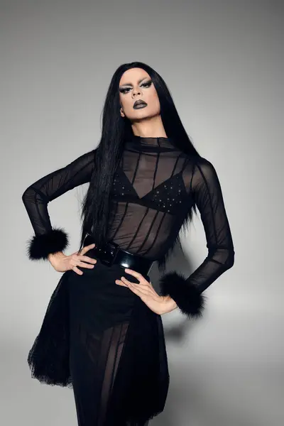 A captivating drag queen embraces gender fluidity in a bold black outfit, exuding confidence and style. — Stock Photo