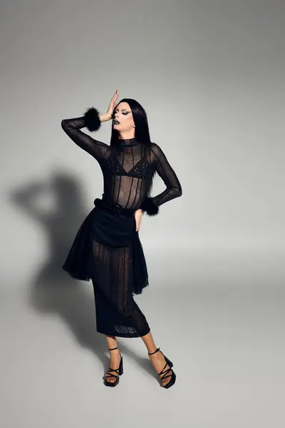 A stylish drag queen poses confidently in a chic black ensemble, embodying fashion and artistry. — Stock Photo