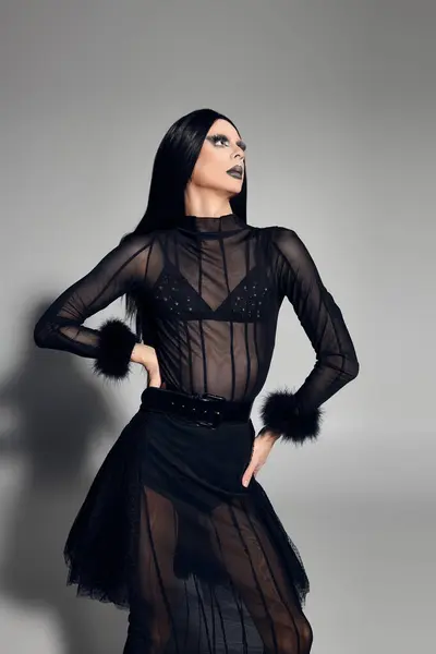 A fashionable drag queen poses confidently in a chic black outfit, embodying elegance and boldness. — Stock Photo