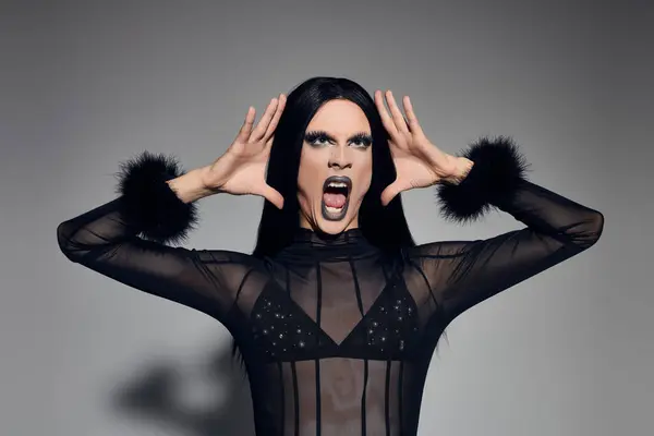 A vibrant, confident drag queen showcases style and expression in a striking black ensemble, embodying art. — Stock Photo