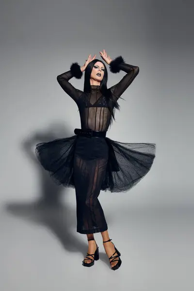 An elegant drag queen poses confidently in a chic black ensemble, expressing unique fashion artistry. — Stock Photo