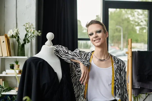 A fashionable transgender designer radiates confidence while working on a stylish creation in their studio. — Stock Photo