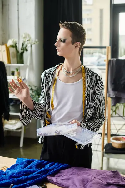 A stylish individual experiments with designs in a fashion studio, surrounded by vibrant materials and inspiration. — Stock Photo