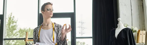 In a stylish studio, a gender fluid designer crafts unique fashion, expressing artistry and individuality. — Stock Photo