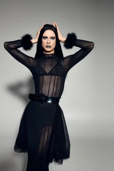 A fashionable and gender fluid person displays a stunning black ensemble, highlighting creativity and style. — Stock Photo