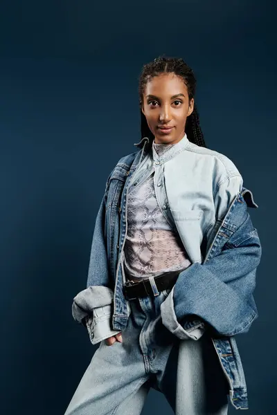 A fashionable young woman poses elegantly in chic denim attire, exuding confidence and style. — Stock Photo