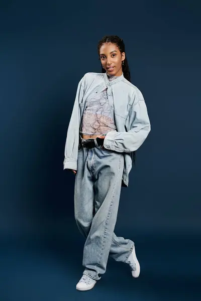 A confident young woman showcases her unique fashion sense in a chic outfit with a vibrant top. — Stock Photo