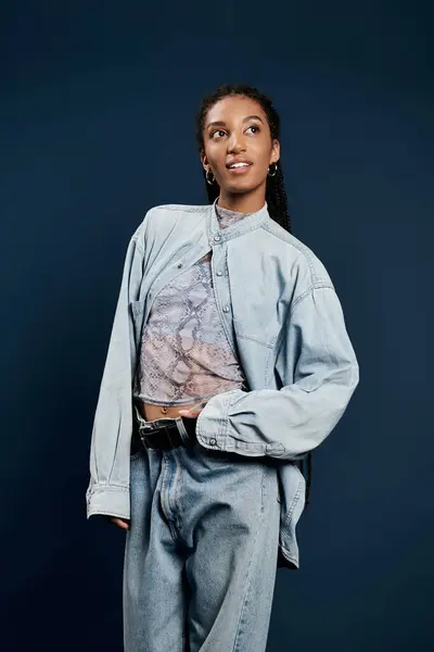 Dressed in chic layers, a young woman showcases her trendy fashion sense with poise. — Stock Photo