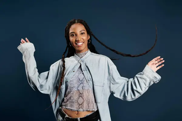 Styled in contemporary fashion, a young woman exudes joy and confidence in her pose. — Stock Photo
