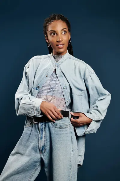 A beautiful young woman showcases her trendy denim ensemble while exuding charm and confidence. — Stock Photo