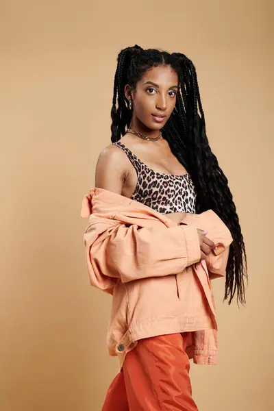 A stylish young woman poses stylishly with long hair, radiating confidence and elegance. — Stock Photo