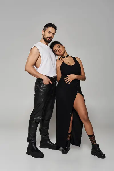 A couple stands close together, exuding affection and confidence in their fashionable outfits. — Stock Photo