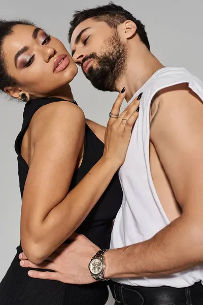 A couple shares a tender embrace, showcasing their love and attraction in a chic atmosphere. — Stock Photo