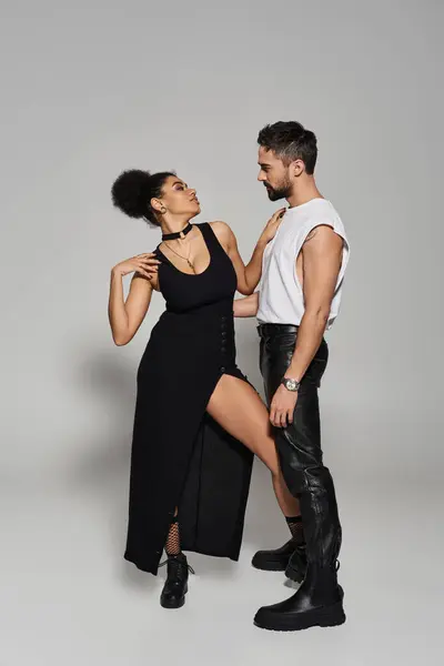 Two lovers embrace in a playful dance, showcasing their chemistry and fashion choices. — Stock Photo