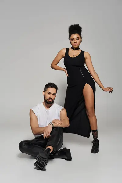 A loving couple poses confidently, showcasing stylish outfits and a deep connection between them. — Stock Photo