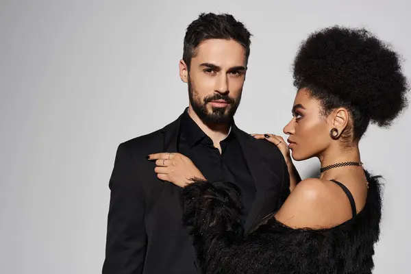 A loving couple shares a tender embrace, showcasing their connection and style. — Stock Photo