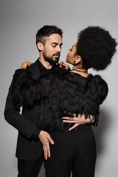 A loving couple shares a passionate moment, showcasing their deep connection and fashion sense. — Stock Photo